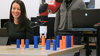 Student with a robot playing a game