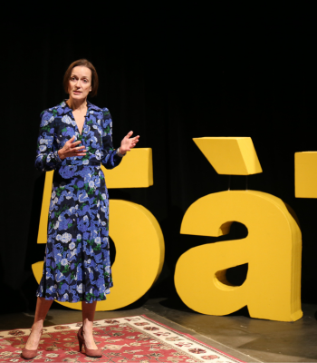 Kerstin de Wit standing on a dark stage...