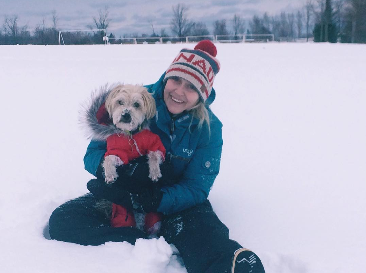Sarah in the snow with her dog Odin (taken from her Instagram)