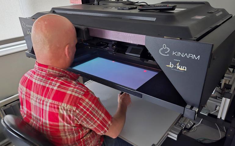 Person using the Kinarm robotic equipment
