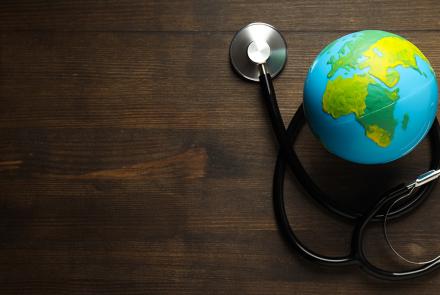 Stethoscope surrounding a model of the earth