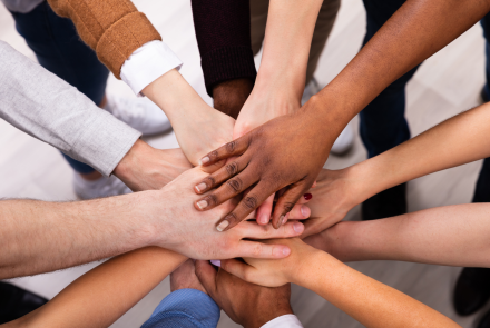 people's hands in the middle, photo looking up from below the centre