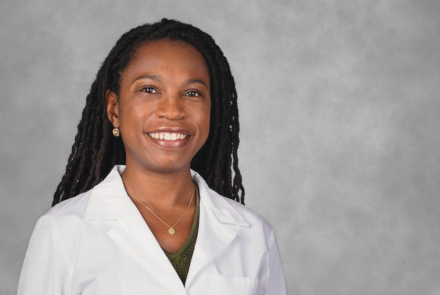 Headshot of Dr. Oluwadamilola M. Fayanju smiling and looking directly into the camera with a grey backdrop behind her
