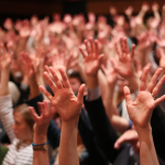 Hands raised at the first annual employee engagement event.