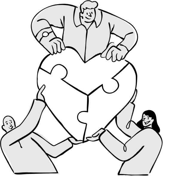 Three people collaboratively assembling a large heart-shaped puzzle, with one person on top placing the final piece.