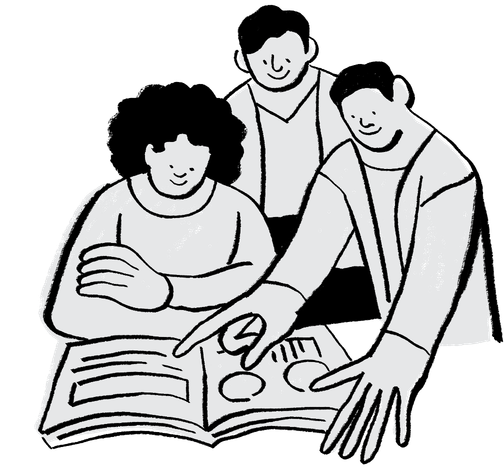 Three people gathered around an open book, with one person pointing to a diagram within it.
